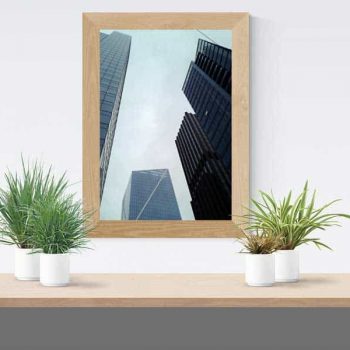 A poster of a city skyline framed and hanging on a wall