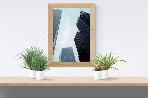 A poster of a city skyline framed and hanging on a wall