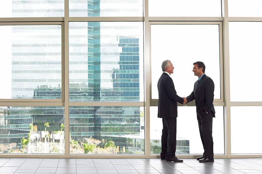 2 Men Shaking hands in Commercial Building