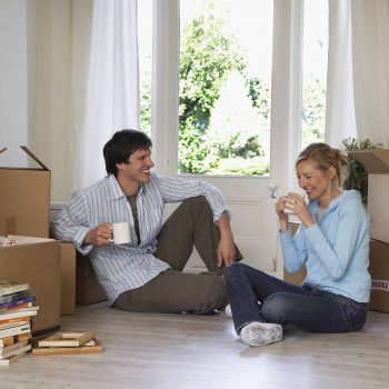 A couple enjoys a coffee break before finishing up their packing for a move.