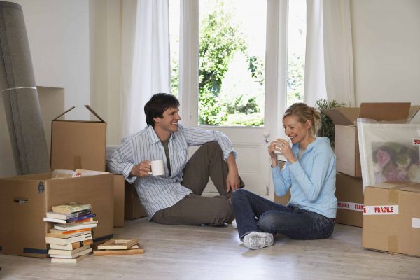 A couple enjoys a coffee break before finishing up their packing for a move.