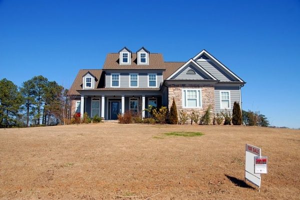 Two story brick and sky blue home for sale