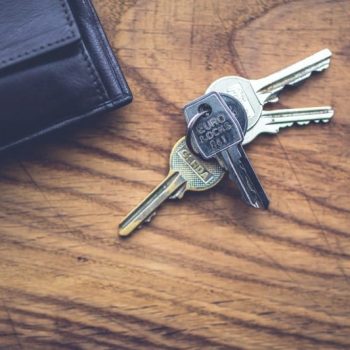 House keys and wallet on wooden table in San Marcos Texas home for sale