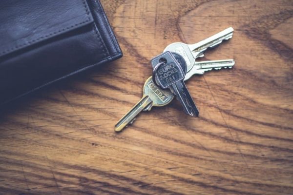 House keys and wallet on wooden table in San Marcos Texas home for sale