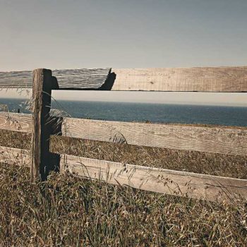 Wooden fence overlooking vacant lot for sale