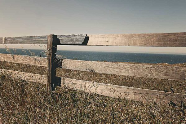 Wooden fence overlooking vacant lot for sale