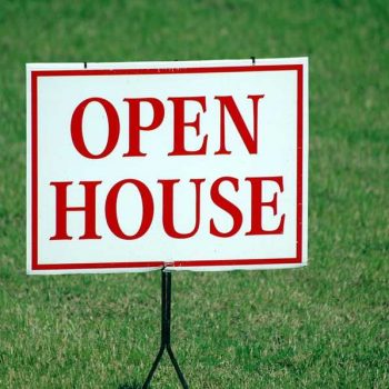 San Marcos real estate open house sign on green lawn