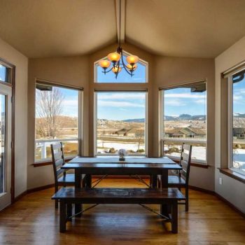 Residential dining room with a window viewing a neighborhood