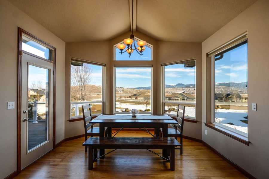 Residential dining room with a window viewing a neighborhood