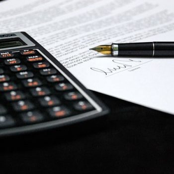 Calculator alongside signed document