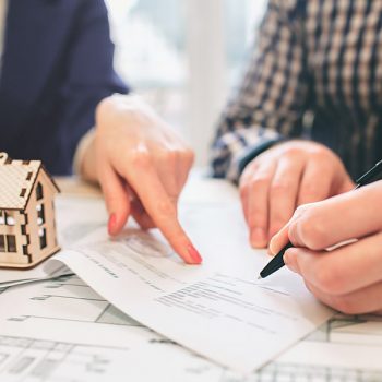 Man Signing a contract for a house