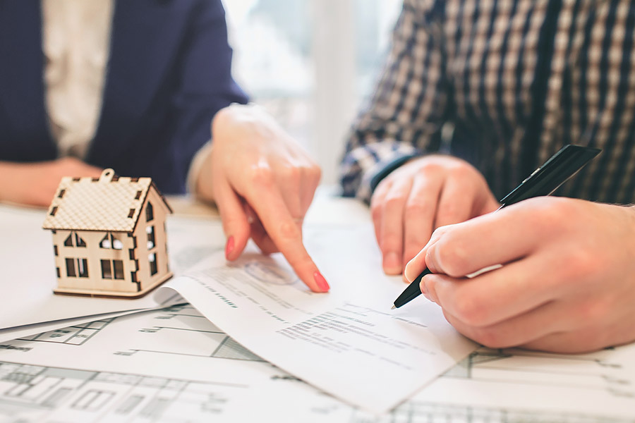 Man Signing a contract for a house