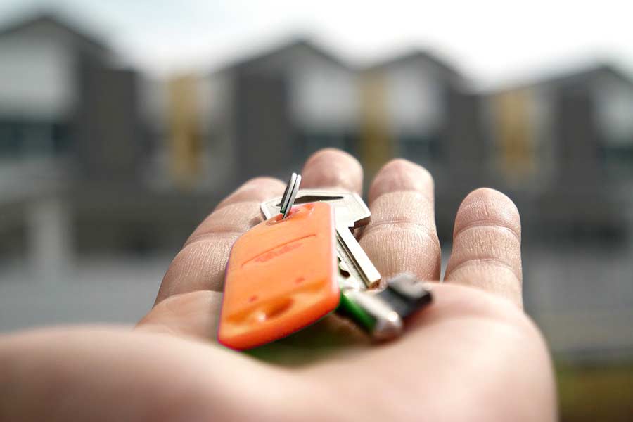 A hand presenting a new set of house keys