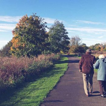 A retired couple enjoying a leisurely walk