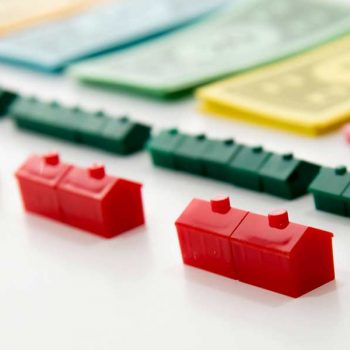 Monopoly houses and money laid out in a row