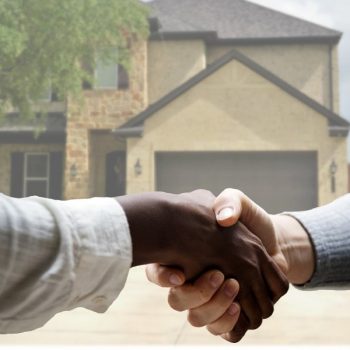 Handshake with real estate agent in front of home