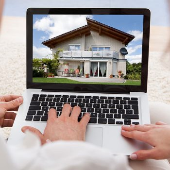 Couple looking at homes for sale on a computer