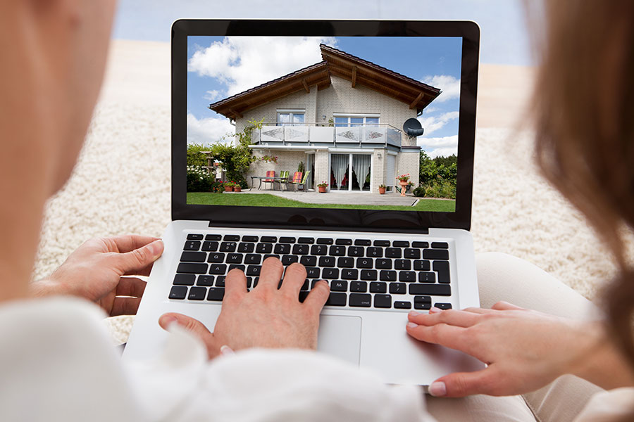 Couple looking at homes for sale on a computer