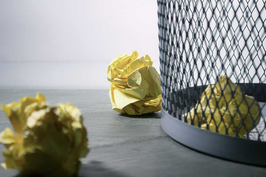 waste basket with crumpled up offers