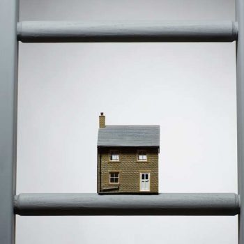 model of a house on a ladder rung