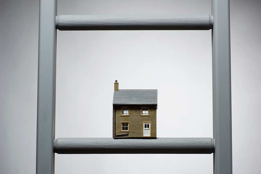 model of a house on a ladder rung