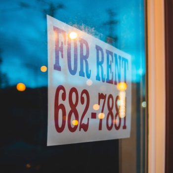 rental property with a for rent sign in the window