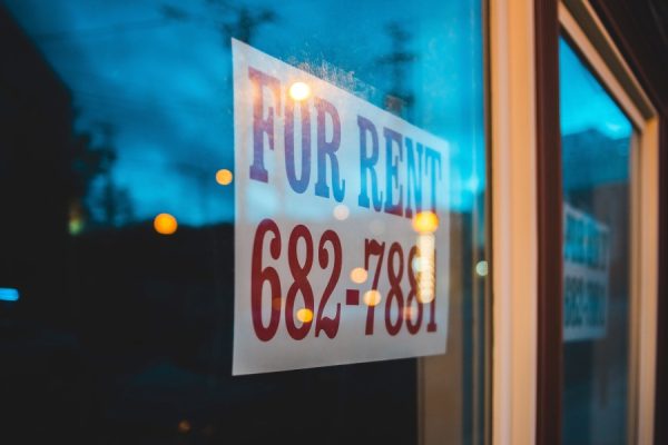 rental property with a for rent sign in the window