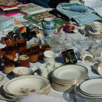 plates, dishes, and other trinkets at a garage sale