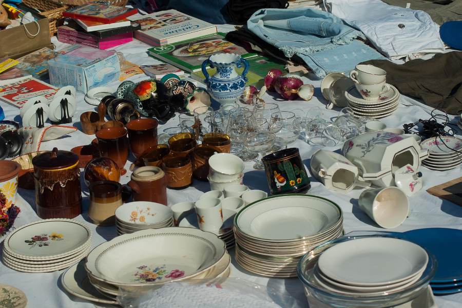 plates, dishes, and other trinkets at a garage sale